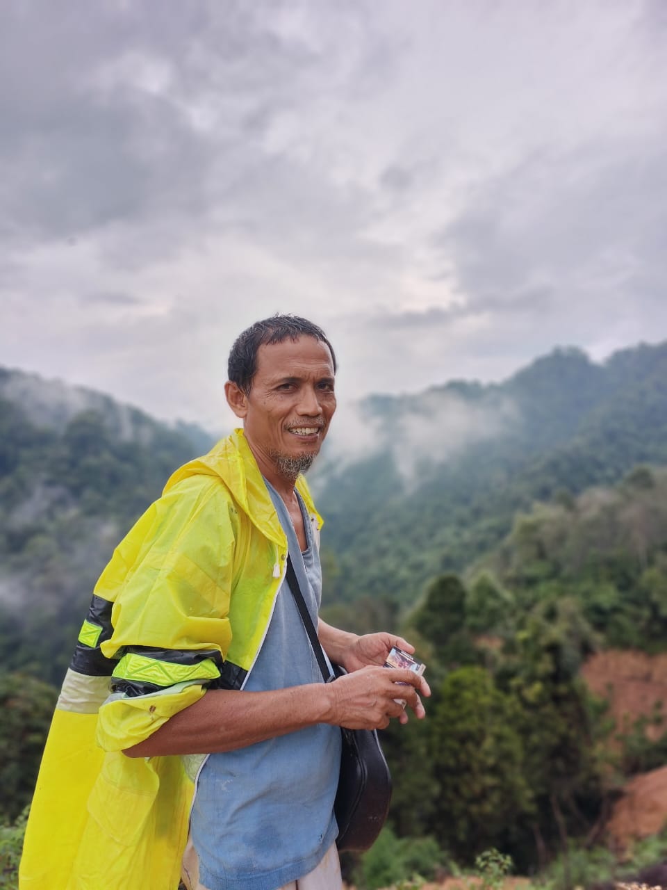 Pak Aca overlooking a forest landscape near Bukit Lawang