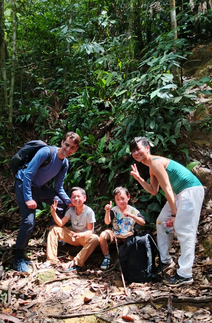 Visitors walking with a local guide in the Bukit Lawang rainforest